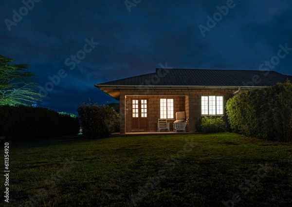 Fototapeta A Captivating House Under the Serene Blue Hour Sky