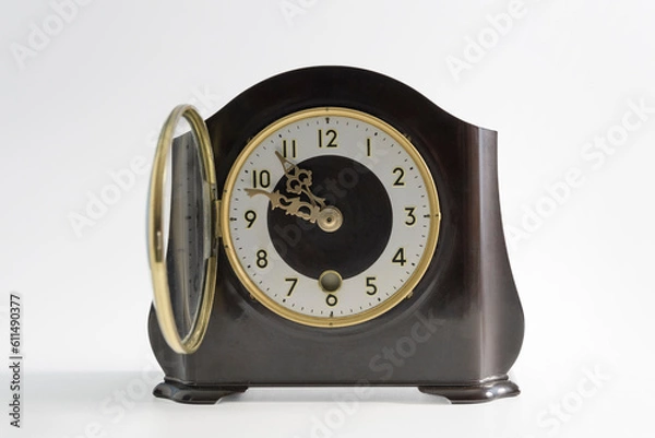Fototapeta Antique table clock with an open front glass cover for the supply of arrows. Traces of time, scuffs on the surface.