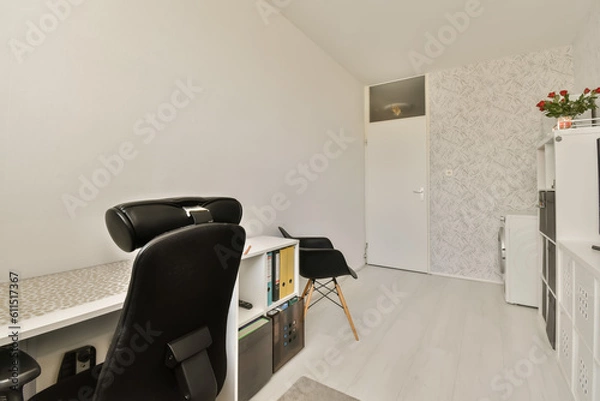 Fototapeta a room with a desk, chair and television set in the corner on the left side of the room is a white wallpaper