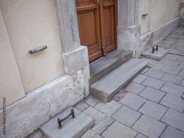 Fototapeta iron pieces set on the pavement to remove mad on the shoes in front of the door of cathedral in lviv old city