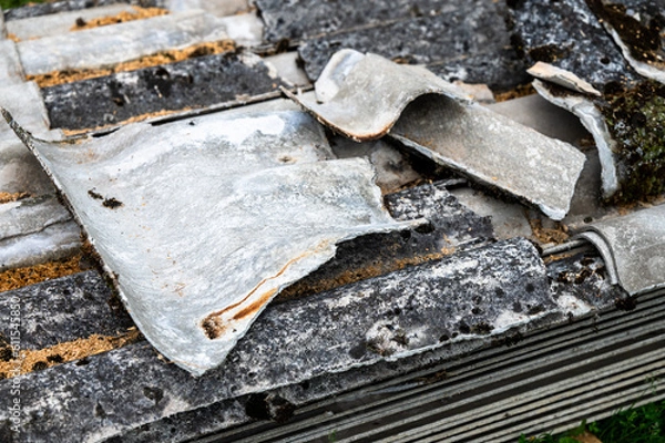 Fototapeta A pile of asbestos removed from an old roof. Hazardous waste prepared for disposal.