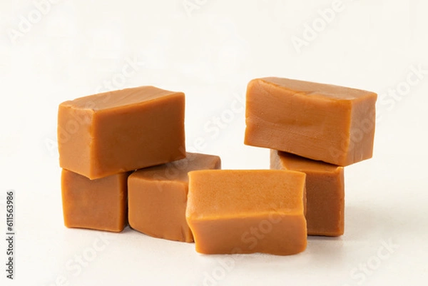 Obraz Caramel candy on pile isolated on white background.