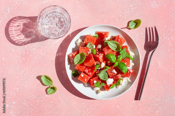 Fototapeta watermelon salad with feta cheese and basil. healthy summer dessert
