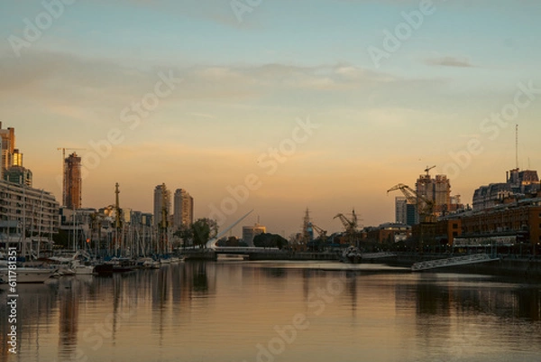 Fototapeta Skyscrapers on the riverside against a sunset backdrop
