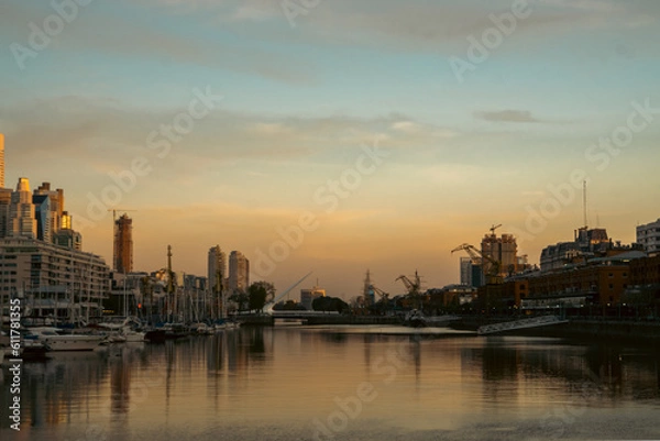 Fototapeta Skyscrapers on the riverside against a sunset backdrop