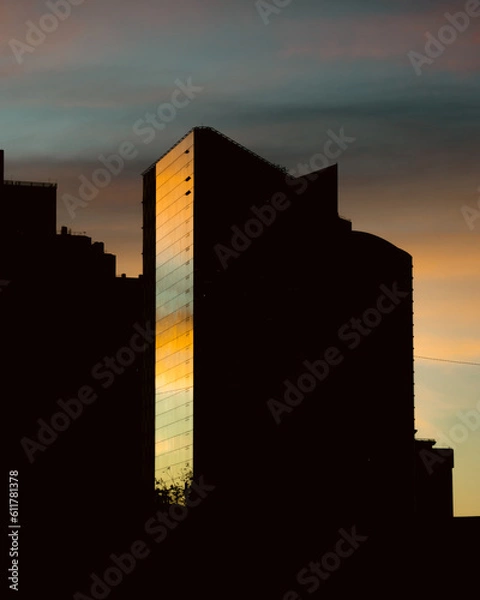 Obraz A silhouette of skyscrapers against a sunset backdrop