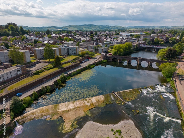 Fototapeta This aerial drone photo shows the town of Dumfries in the district of Dumfries and Galloway in Scotland. You can see the river Nith which flows through the center of the town. 