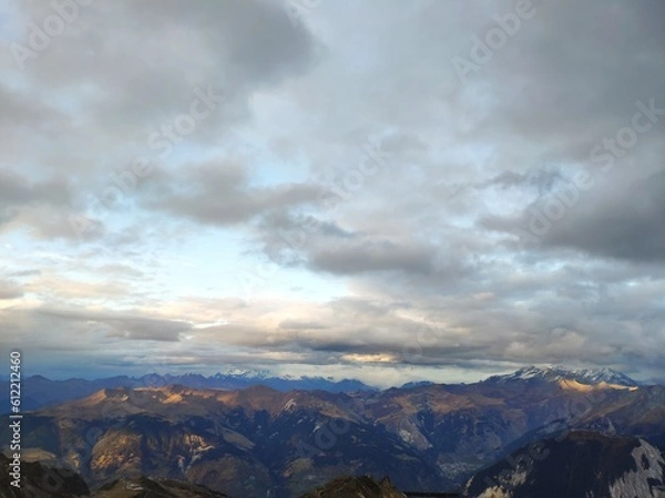 Obraz Mountains range with clouds and blue sky