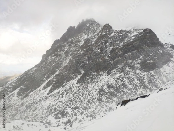 Obraz White snow mountain rocks in alps day time