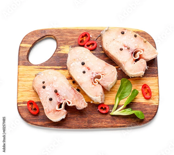 Fototapeta Wooden board with raw cut codfish on white background