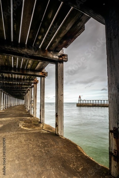 Fototapeta Under interior of a wooden boardwalk bridge
