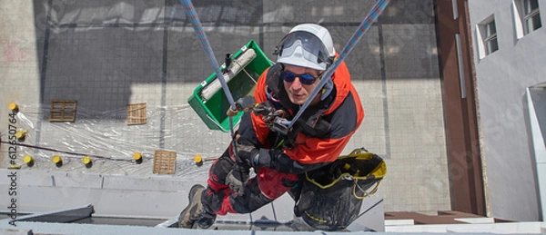 Fototapeta Rope access. Cleaning the windows of the skyscraper.