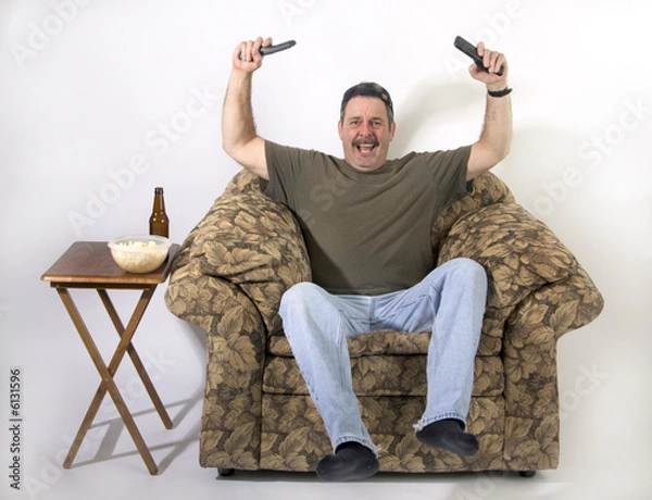 Fototapeta Sports fan celebrating game on TV