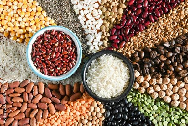 Obraz Bowl with raw white rices and beans on various seeds grain
