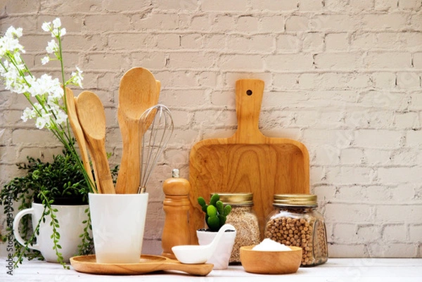 Fototapeta Kitchen accessories in white wooden table and white background and white tableware with salt in wooden bowl and tree. Kitchen minimal cooking time in holiday concept.