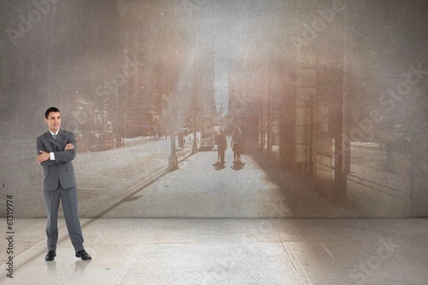 Fototapeta Composite image of businessman with arms folded