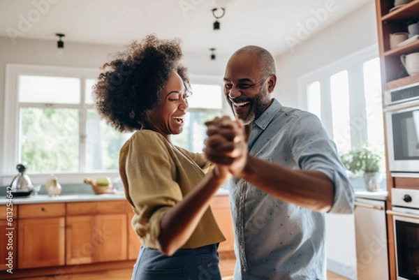 Fototapeta Authentic moment of an African American retired couple sharing a dance in the kitchen, an embodiment of enduring love and romance, generative ai