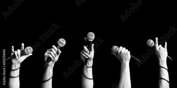 Obraz microphone in singer hand in various poses. black and white. singing and performer concept