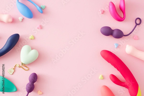 Obraz Concept of adult toys for sexual satisfaction. Top view of vibrator, vaginal balls, dildo, clitoral stimulators and hearts on pastel pink background with an empty space for text or promotional
