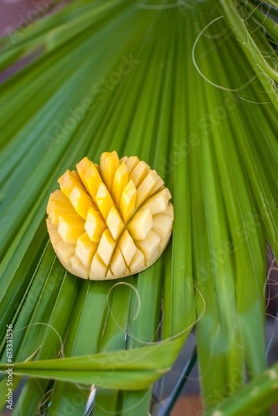 Fototapeta Sliced pineapple with palm leaf