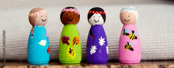 Fototapeta Painted wooden peg dolls of different races; small wooden dolls painted by a child