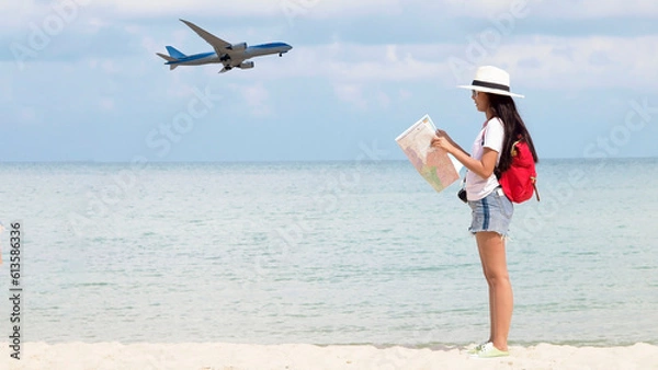 Fototapeta Summer Party. Traveler and tourism woman travel in summer on the beach and white sand. Asian is reading map with red backpack. On working in vacation concept.