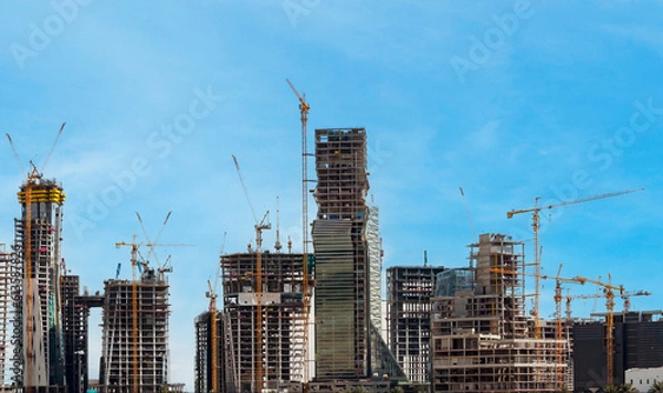Fototapeta Riyadh, Saudi Arabia, KSA - June 18, 2013 buildings being constructed in the new King Abdullah Financial District in Riyadh with cloudy sky