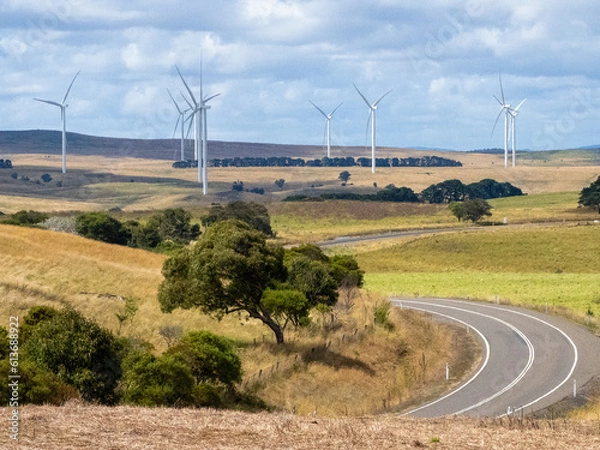 Obraz Landscape view wind turbines in a valley with a road winding through