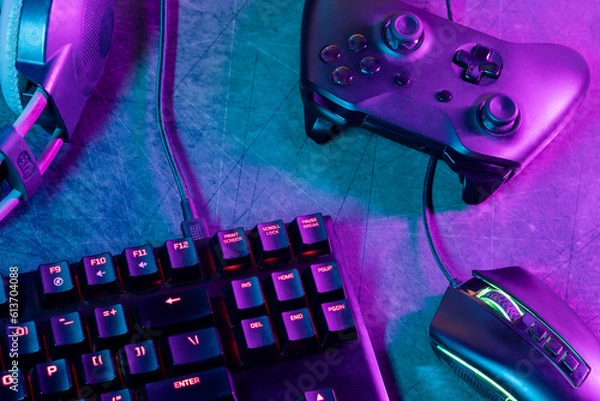 Fototapeta Top view of a gamer's workspace on a desk with an abstract carpet texture and lines.