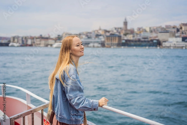 Fototapeta Happy woman enjoying the sea from ferry boat crossing Bosphorus in Istanbul. Summer trip to Istanbul