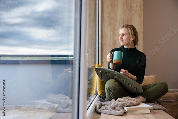 Obraz Beautiful girl drinks coffee by the window. Me-time. Time for relaxation.