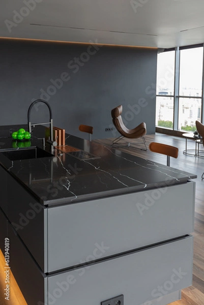 Fototapeta dark minimalistic design of a trendy chic studio apartment with panoramic windows on a high floor overlooking the city