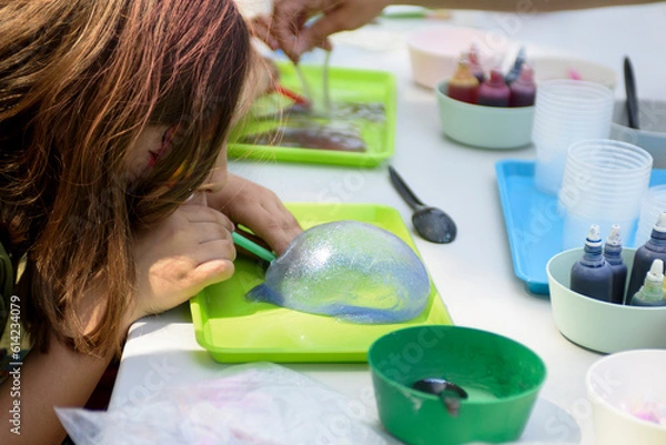 Obraz Making a slime for hands for a children's holiday. Chemical experiments.