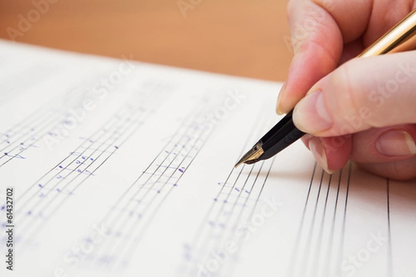 Obraz Hand with pen and music sheet