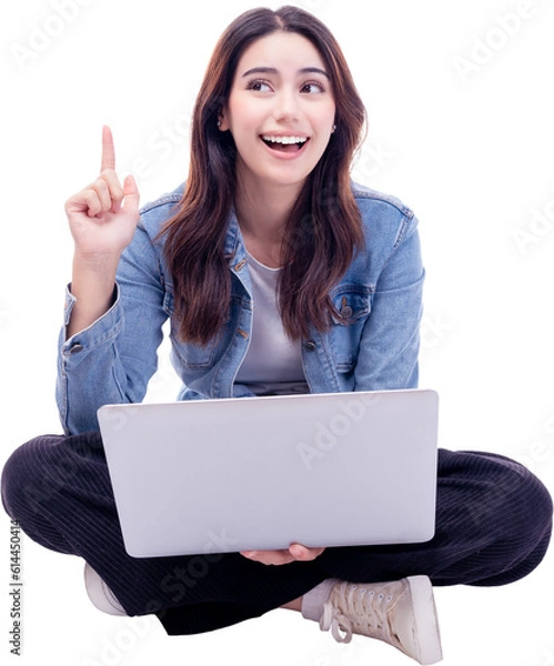 Obraz Young woman sitting on floor legs crossed using laptop computer on white background Smiling student teen girl working on laptop computer Full body of young girl netbook point finger to empty space