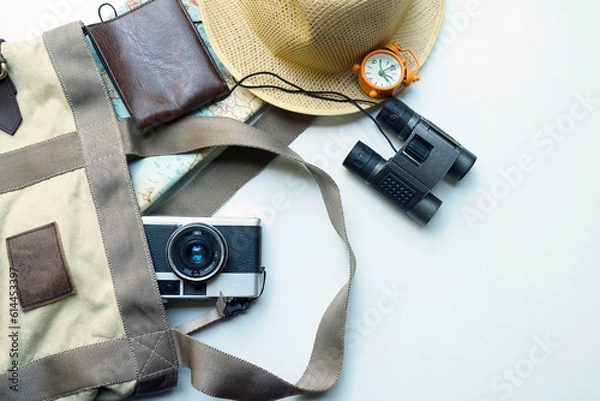 Fototapeta Top view of accessories for tourist to travel in colorful tone on Travel with colorful concept, Camera on  hat on white background for travel in Summer Vacation