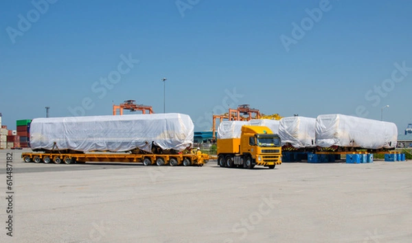 Obraz Transport of Oversize Heavy Machinery cargo truck Loading a new locomotive port area
