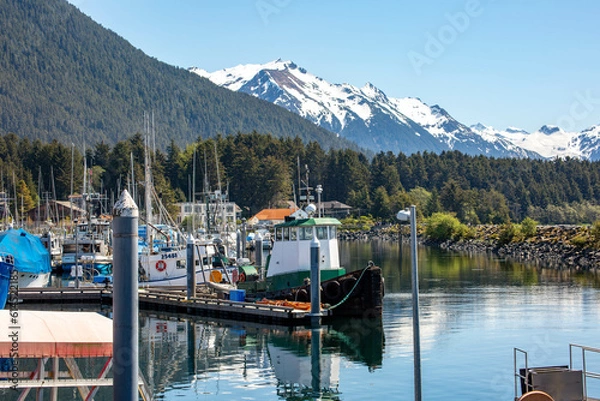 Obraz fishing boats moored in the docks in Sitka Alaska with scenic snowcapped mountains in the background 