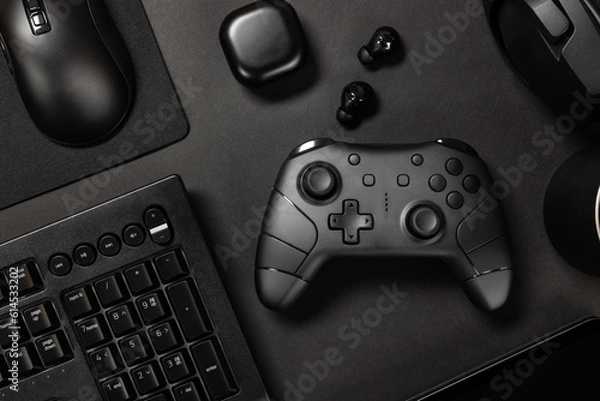 Fototapeta Gaming controller amidst various modern devices