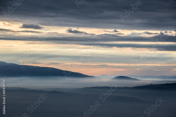Fototapeta Mist and fog between valley and layers of mountains and hills at sunset, in Umbria Italy