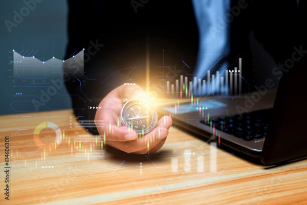Fototapeta Business navigate Reinvent and Recover business growth in the economic crisis, Business man hold a compass with growing graph, financial and business developmet concept.