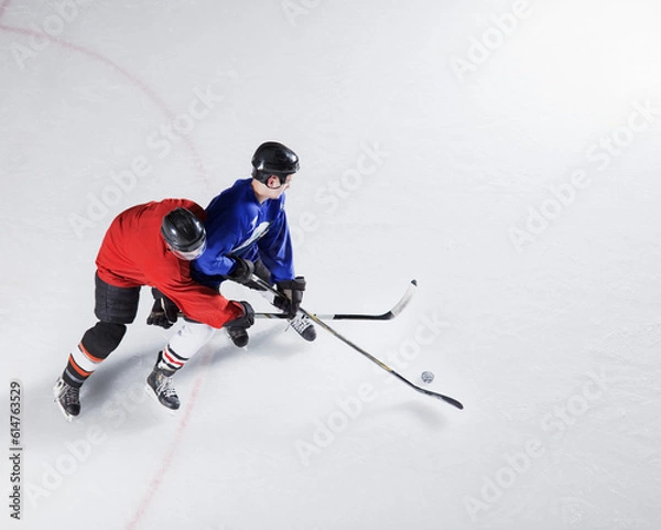 Fototapeta Hockey players going for puck on ice