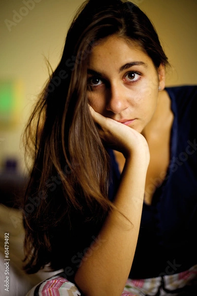 Obraz Young woman posing and thinking in the dark