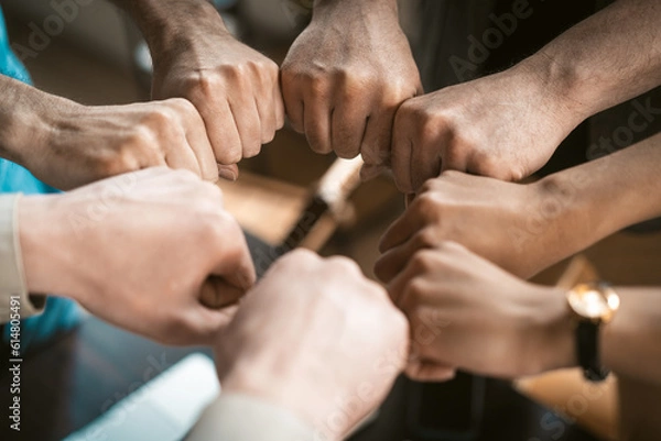 Fototapeta Collaboration, cooperation, and teamwork within professional setting. Individuals demonstrate unity and support as they come together to work as a cohesive unit. Concept of team spirit. High quality