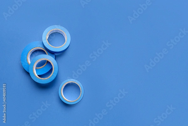 Obraz Adhesive tape rolls on blue background