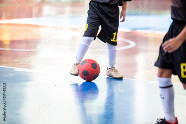 Fototapeta Kid futsal player control the ball for shoot to goal. Indoor soccer sports hall.