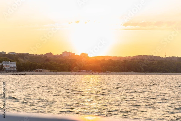 Fototapeta View of the beach from the pier at sunset