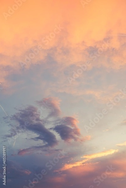 Obraz Beautiful poetic sot of a sky with clouds at sunset dusk with nice pastel yellow blue and pink colors, with airplane contrail 