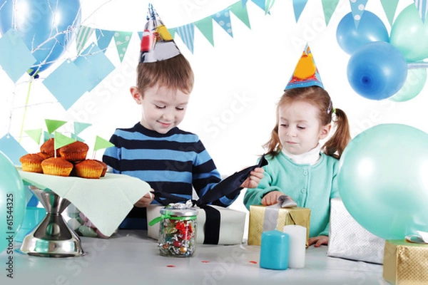 Obraz Two children at blue party table openning present