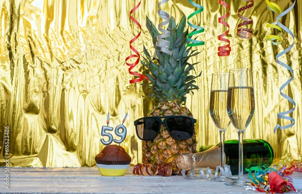 Obraz Cheerful pineapple in glasses festive happy birthday character with number  59. Beautiful background for congratulations copy space on a golden background with glasses of champagne. Anniversary